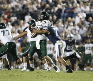 Preston Hadley sacks Hawaii's quarterback Sean Schroeder during a game last season at LaVell Edwards Stadium. Hadley is currently attempting to make an NFL roster. (Photo by Chris Bunker.)
