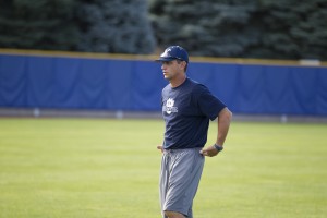 Coach Mike Littlewood coaching baseball players during practice.