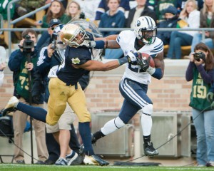 BYU running back Jamaal Williams gives a stiff arm to Notre Dame safety Matthias Farley. Photo by Chris Bunker