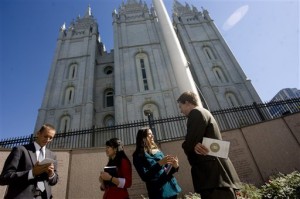 Missionaries Sister Khanitta Puttapong, center left, and Sister Christina Wong, center right, talk to Casey Ahlstrom, left, and Jason Mondon in Temple Square during the 182nd Semiannual General Conference of the Church of Jesus Christ of Latter-day Saints in Salt Lake City on Sunday, Oct, 7, 2012. (AP Photo)