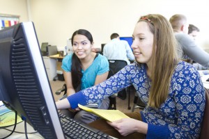 Brittan Herndon, right, helps Angel Saddleback, left, file her taxes in the Tanner Building on Thursday afternoon.