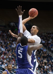 BYU forward Brandon Davies shoots over Washington defender Aziz N'Diaye during Tuesday's game at the Marriott Center. (Photo by Chris Bunker)