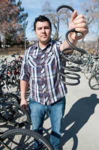 Bruce lang shows his bike lock which was cut last month. His bike was stolen, but fortunately, police found it in a pawn shop on March 22. (Photo by Chris Bunker)