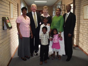 Eleanor Wiblin (back, center) with her husband and the Govender family. When the Eleanor Wiblin lived in South Africa, her husband was the 1st Branch President of an Indian (Asian) branch and there was a little boy who is now the Bishop of that ward   pictured here (photo courtesy Eleanor Wiblin)