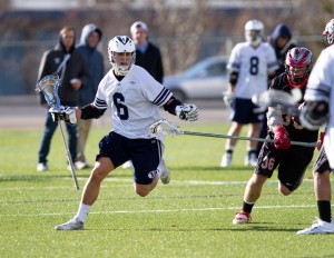 Sophomore attackmen Mike Fabrizio wards off a New Mexico defensemen. BYU plays three away games in seven days. (Photo by Sarah Hill)