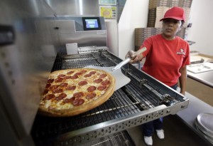 Rosy Tirado pulls a pepperoni pizza from an oven at a Pizza Patron Dallas, Texas. While lower-wage American workers have accounted for the lion's share of the jobs created since the 2007-2009 Great Recession, a survey released March 2013 shows that they are also among the most pessimistic about their future career prospects, their job security and their finances. (AP Photo/Tony Gutierrez)