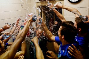 Florida Gulf Coast players shower their coach Andy Enfield with water in the team's locker room after winning a third-round game against San Diego State in the NCAA college basketball tournament, Sunday, March 24, 2013, in Philadelphia. Florida Gulf Coast won 81-71. (AP Photo/Naples Daily News, Scott McIntyre)
