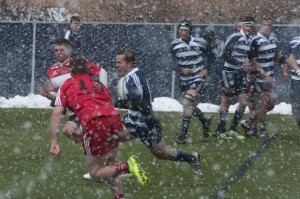 A BYU player splits two SUU defenders. The BYU rugby team outscored SUU 98-3. (Photo by Whitnie Soelberg)