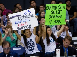 Fans hold up signs during a game in the Smith Fieldhouse. (Photo by Sarah Hill)