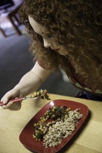 Averi Crockett eats a vergetarian meal of sauted red chard, tomatoes, chick peas, and wild rice.