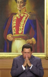 Venezuela's President Hugo Chavez gestures before a painting of Venezuelan independence hero Simon Bolivar at an event at Miraflores presidential palace in Caracas, Venezuela. Venezuela's Vice President Nicolas Maduro announced on Tuesday, March 5, 2013 that Chavez has died.   (AP Photo/Leslie Mazoch, File)