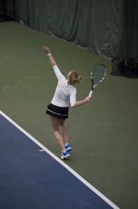 Morgan Anderson serves in her Feb. 8 match. The Cougars fell to Utah 5–2 Saturday. (Photo Sarah Hill)