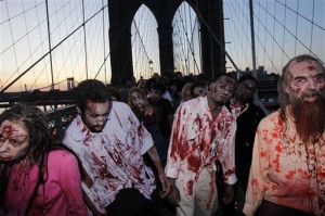 Costumed actors, promoting the Halloween premiere of the AMC television series "The Walking Dead", shamble along the Brooklyn Bridge while posing for pictures in New York in October. (AP Photo)