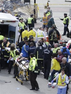 Medical workers aid injured people at the finish line of the 2013 Boston Marathon following an explosion in Boston.(AP Photo)