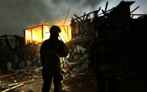 Firefighters use flashlights early Thursday morning to search a destroyed apartment complex near a fertilizer plant that exploded Wednesday night in West, Texas. (AP Photo)