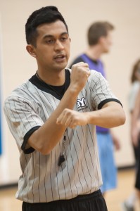 BYU intramural referee Joshua Jamias signals a personal foul to the scorer's table during an intramural basketball game. (Photo by Chris Bunker) 
