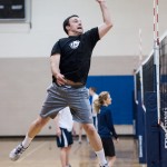 Student Ryan Vance goes up and hits the ball during an intermediate volleyball class in the Richards Building. (Photo by Chris Bunker)