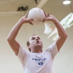 Student Tanner Shaw sets the ball during an intermediate volleyball class in the Richards Building. (Photo by Chris Bunker)