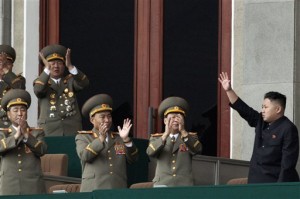 North Korean leader Kim Jong Un, left, waves as North Korean military officers clap at a stadium in Pyongyang. (AP Photo)