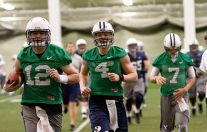Three of the team's young quarterbacks. left Tanner Mangum, center Taysom Hill, and right Christian Stewart, leave the field on Wednesday during spring training.
