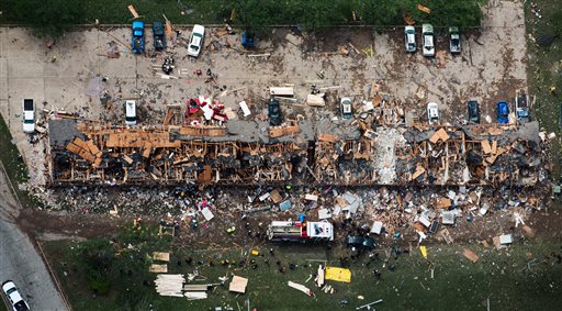 In this aerial photo, law enforcement and rescue personnel search the damage to an apartment complex from the explosion of the West Fertilizer plant on Thursday, April 18, 2013, in West, Texas. A massive explosion at the plant killed as many as 15 people and injured more than 160, officials said overnight. (AP Photo/Houston Chronicle, Smiley N. Pool)