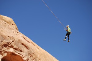 An unidentified woman swinging from the Corona Arch near Moab, Utah. The high-risk sport of swinging wildly on ropes through canyon and arch openings in southern Utah has left a second man dead in little more than a month.   (AP Photo/The Salt Lake Tribune, Brian Maffly, File)