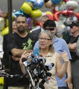 Nancy Ruiz, mother of Gina DeJesus, speaks to the media after bringing her daughter home Wednesday, May 8, 2013, in Cleveland. The three women held captive for about a decade at a run-down Cleveland house were apparently bound with ropes and chains, police said. (AP Photo by Tony Dejak)