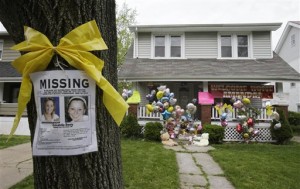 A missing poster still rests on a tree outside the home of Amanda Berry Wednesday, May 8, 2013, in Cleveland. (AP Photo)