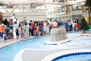 Crowds line the pool deck of the new recreation center during Saturday's open house. (Photo by Sarah Hill)