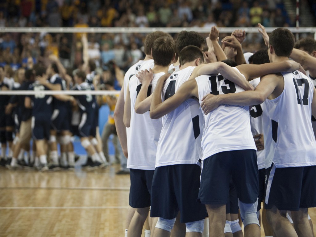 BYU's Men's Volleyball Team huddles together as UCI celebrates their national championship.