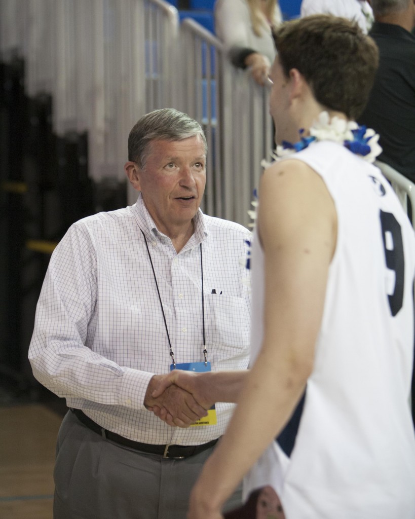 President Samuelson shakes hands with BYU volleyball players after their loss to UCI.