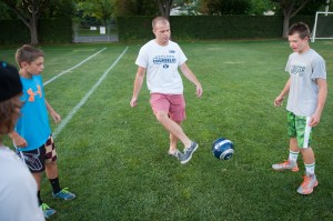 Matt Babcock plays soccer with his campers.  (Photo by Chris Bunker)