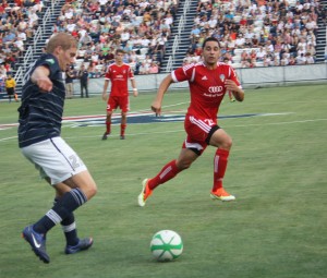 James Bindrup goes up against an FC Tuscon defender in the Cougars' July 4th Game. The Cougars won   . Photo by Samantha Jensen.