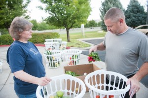 Scott Bishop, right, goes through his fruit and vegetables as Michele Woodard helps. (Photo by Chris Bunker)
