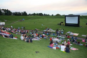 Visitors gather to watch a free outdoor movie at Rock Canyon Park.