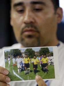 FILE - In this May 2, 2013 file photo, Jose Lopez points to a undated photo of Ricardo Portillo, center, his brother-in-law, following a news conference, at Intermountain Medical Center, in Murray, Utah. The attorney for a Utah teenager accused of killing a soccer referee with a single punch has acknowledged there is probable cause the teen committed the crime. The teenager's attorney, Monte Sleight, made the concession Friday, Aug. 2, 2013 in a private meeting with prosecutors and Juvenile Court Judge Kimberly Hornak, court records show. (AP Photo/Rick Bowmer, File)