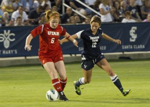 BYU freshman defender Avery Calton takes the ball away from a Utah player on Sept. 6. (Photo by Ari Davis.)