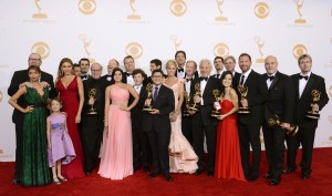 Cast and crew from "Modern Family" pose with their Emmy for outstanding comedy series backstage at the 65th Primetime Emmy Awards at Nokia Theatre on Sunday Sept. 22, 2013, in Los Angeles.  (Photo by Dan Steinberg/Invision/AP)