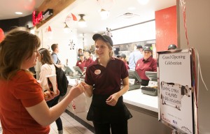 Hannah Rowley passes Chick-fil-A orders to customers during Thursday's grand opening celebration in the Wilkinson Center. Photo by Sarah Hill