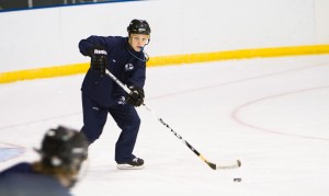 BYU hockey head coach Josh Burkhart runs drills with the men's hockey team. Photo by Sarah Hill.