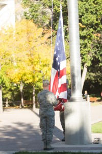 Two men take down the flag infront of the ASB at 5:30 as the National Anthem plays in the background. Photo by Ari Davis