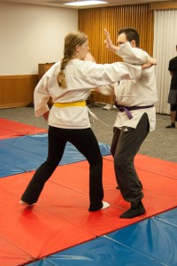 Husband and wife, Quinn and Whitney Winn, practice self-defense moves for the Jujitsu club. (Photo by Maddi Dayton.)