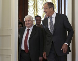 Russian Foreign Minister Sergey Lavrov welcomes his Syrian counterpart Walid al-Mouallem, left, prior talks in Moscow on Monday, Sept. 9, 2013. (AP Photo/Ivan Sekretarev)