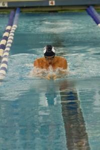 A member of the BYU swim team races in the 100 yard breaststroke during a meet last season. The swim team prepares for the 2013 season with the alumni meet on Sept. 20 (Photo by The Universe)
