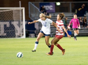 Annie Amos wards off an Oklahoma defender during Thursday's win over Oklahoma. Photo by Sarah Hill.