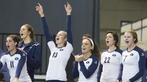 BYU volleyball players celebrate their five set win against Uah. Photo by Bella Torgerson.