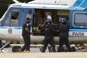 A U.S. Park Police helicopter is loaded on the Mall in Washington, Thursday, Oct. 3, 2013, with a victim from a shooting. Police say the U.S. Capitol has been put on a security lockdown amid reports of possible shots fired outside the building.  (AP Photo/Alex Brandon)