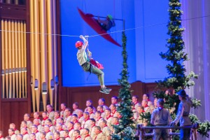 A Scout rides a zipline across the conference center while another Scout kayaks while suspended next to the Conference Center organ as part of "A Century of Honor"