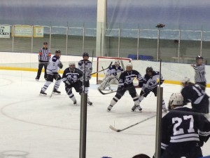 BYU and Utah State fight for possession of the puck (photo courtesy of Carol Naumu)