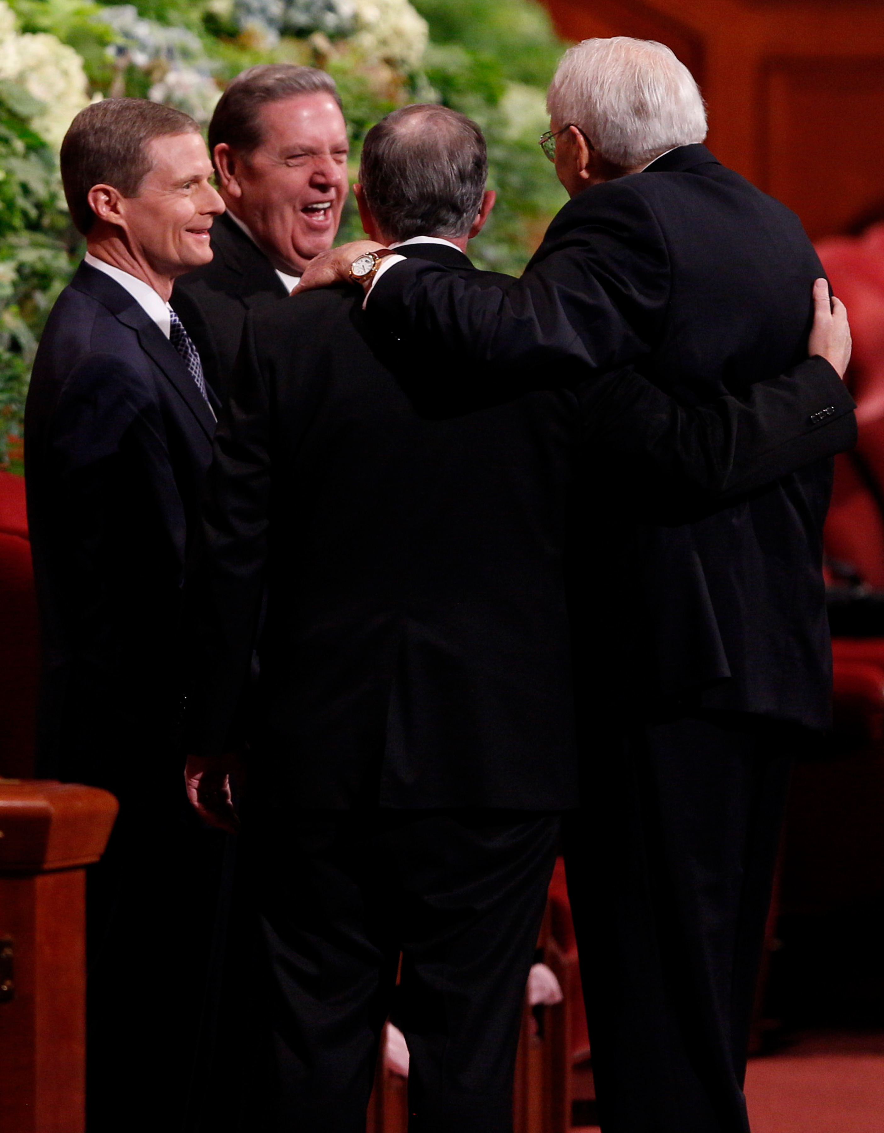 Elders David A. Bednar, Jeffrey R. Holland, Neil A. Andersen and Tom L. Perry of the Quorum of the Twelve Apostles greet each other prior to the start of the Saturday morning session of general conference, 5 October 2013. Photo courtesy IRI.